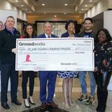 St. Jude Research Hospital Staff and Matt Malone are holding a donation.
