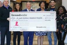 St. Jude Research Hospital Staff and Matt Malone are holding a donation.