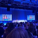 a woman speaks to the crowd at the 2025 Evening of Wishes