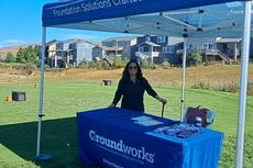 A Groundworks Denver teammate staffs a company booth at the Links for Lungs Golf Tournament