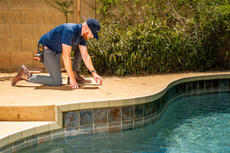 Groundworks certified field inspector examining cracks in concrete pool deck in Phoenix, AZ.