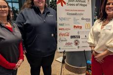 Three Groundworks New Haven crew members at RMHC Trees of Hope 2025 sponsorship event standing with fundraiser sign
