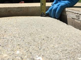 image of uneven concrete slabs that are a trip hazard