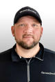 A man in a black "Groundworks" hat and shirt, facing forward, against a plain light background.