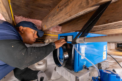 Groundworks service tech working on humidifier.