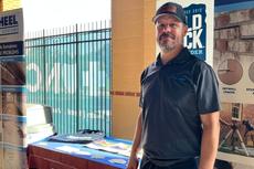Tar Heel Basement Systems (now Groundworks Raleigh) employee at a company booth during a Durham Bulls game