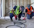 image of Groundworks employees injecting polyurethane grout curtain wall at cliff side hotel.