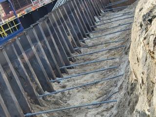 image of helical anchors, also called tiebacks, which were used to provide stability and load bearing capacity to this shipyard bulkkhead