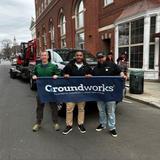 Groundworks employees holding a company sign and standing in front of a company truck at the 2026 New Haven St. Patrick's Day Parade