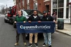 Groundworks employees holding a company sign and standing in front of a company truck at the 2026 New Haven St. Patrick's Day Parade