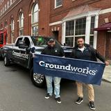 Groundworks employees holding a company sign and standing in front of a company truck at the 2026 New Haven St. Patrick's Day Parade