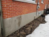 melting snow near a house foundation