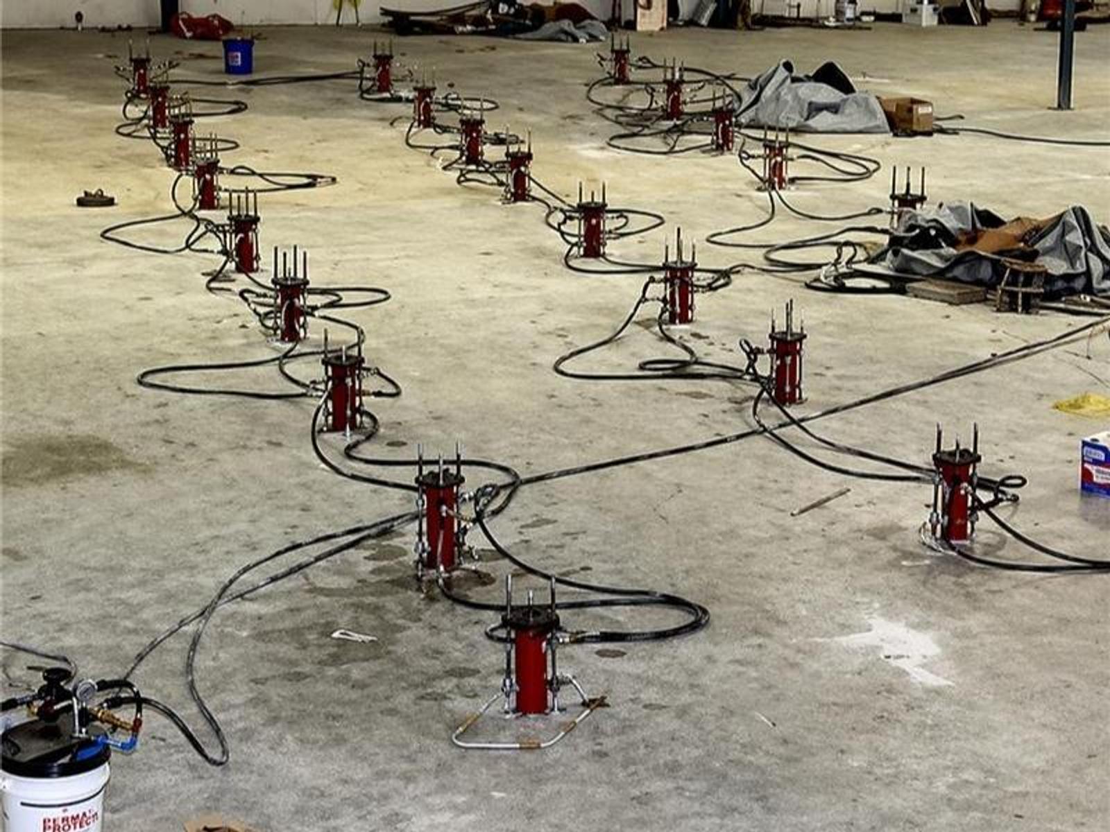 image of lift cylinders to install slab push piers from Groundworks