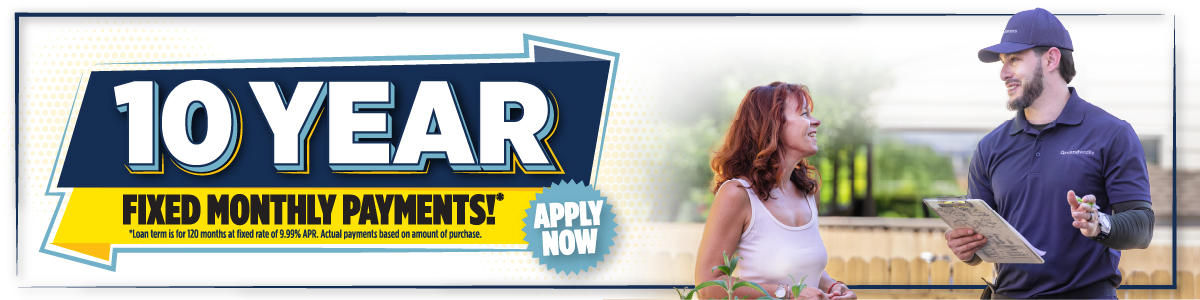 Banner reads "10 Year Fixed Monthly Payments* Apply Now" with a woman and a worker talking outdoors.