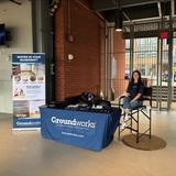 A Groundworks New Haven employee at a company booth at a Hartford Yard Goats baseball game