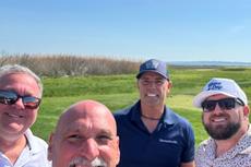 Groundworks Boston employees stand together on the green at the Make-A-Wish Golf Outing