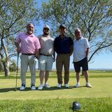 Groundworks Boston employees stand together on the green at the Make-A-Wish Golf Outing