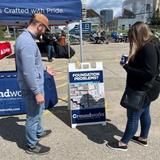 a Groundworks employee talks about our services with a visitor at the Roll'N Out Food Truck Festival in Grand Rapids