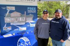 Groundworks employees stand at a company booth at Walk for Wishes 2026 at the Detroit Zoo