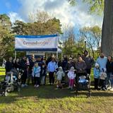 Groundworks employees and family members stand next to a company banner at the 2026 Walk for Wishes at the Detroit Zoo