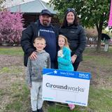 Groundworks employees and family members stand next to a company sign at Walk for Wishes 2026 at the Detroit Zoo