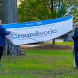 Groundworks employees assemble a company banner at Walk for Wishes 2026 at the Detroit Zoo