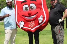 Indiana Foundation Service teammates with the Salvation Army mascot at the Golf 4 Kids tournament