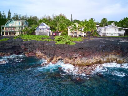Three houses on stilts near the coastline in Hawaii