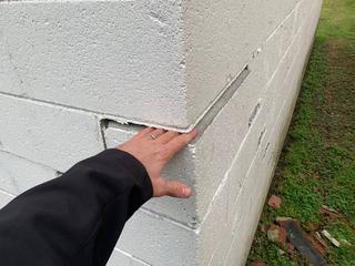 image of structural damage to cinderblock building