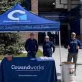 Groundworks Bozeman employees stand at a company table at the Sonny Holland Spring Game & Food Drive