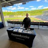 Groundworks employee standing at a company table at a Scranton/Wilkes-Barre RailRiders home game