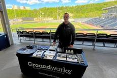 Groundworks employee standing at a company table at a Scranton/Wilkes-Barre RailRiders home game