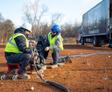 Groundworks employees performing polyurethane injection soil stabilization and soil densification