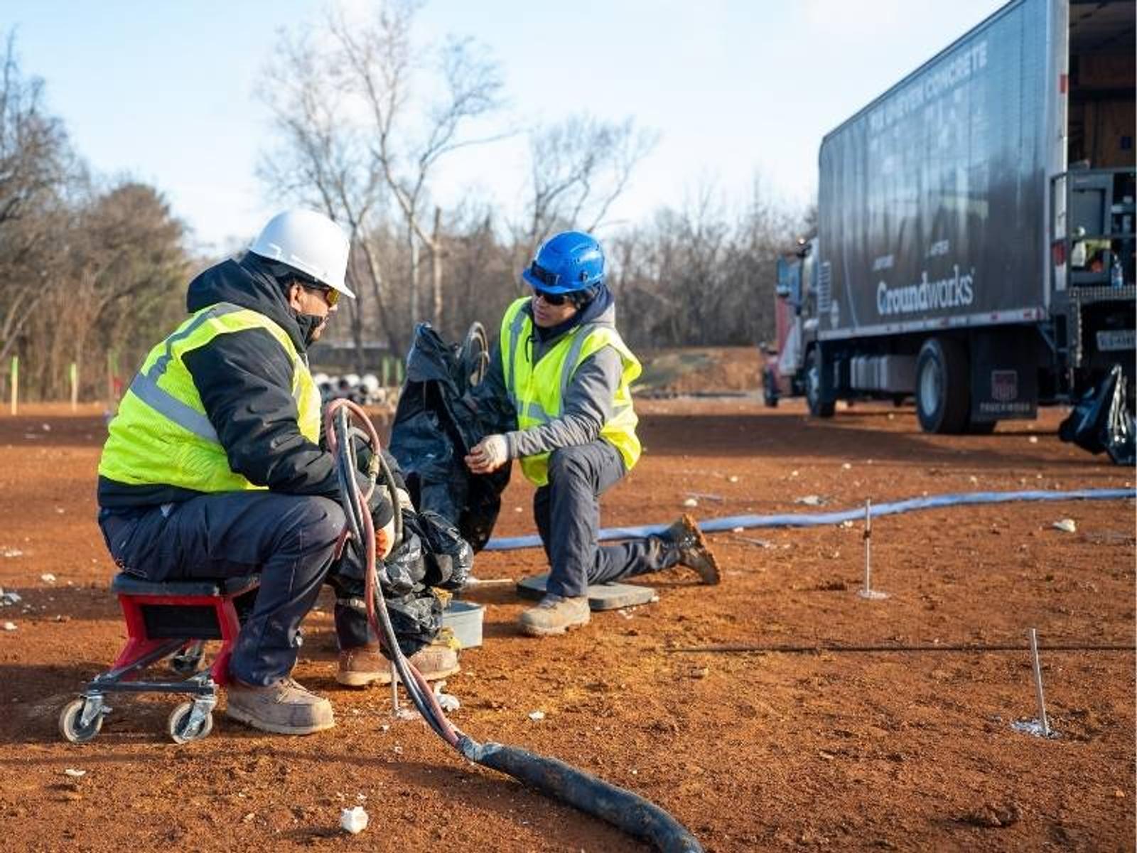 Groundworks employees performing polyurethane injection soil stabilization and soil densification