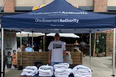 Ohio Basement Authority employee in a company tent at the 2025 ESPN Cleveland Block Party