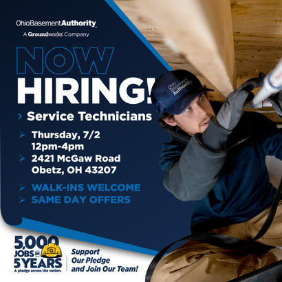 A man in work gear uses a tool; Ohio Basement Authority is hiring service technicians with same day offers.