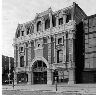Historic Orpheum Theatre on Main Street in Dubuque, Iowa, shown from the front with ornate neoclassical facade.