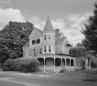 Victorian-era home with a turret, wraparound porch, and ornate exterior details.