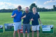 Groundworks West Virginia employees stand next to sponsorship signs at the Southern WV Home Builders Association's 8th Annual Charity Golf Outing