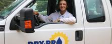 Man smiles from front seat of a truck