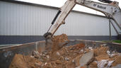 Bobcat digging soil