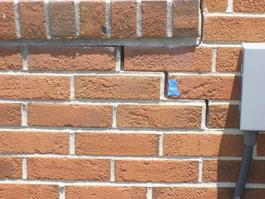 stair step crack in brick under window