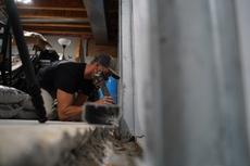 Crew installing full basment waterproofing and wall repair solution