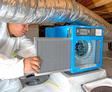 Crew installing dehumidifier in crawl space
