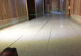 sloping and uneven floor with cracked tiles