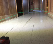 sloping and uneven floor with cracked tiles