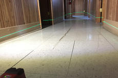 sloping and uneven floor with cracked tiles