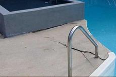 Cracked pool deck before concrete leveling