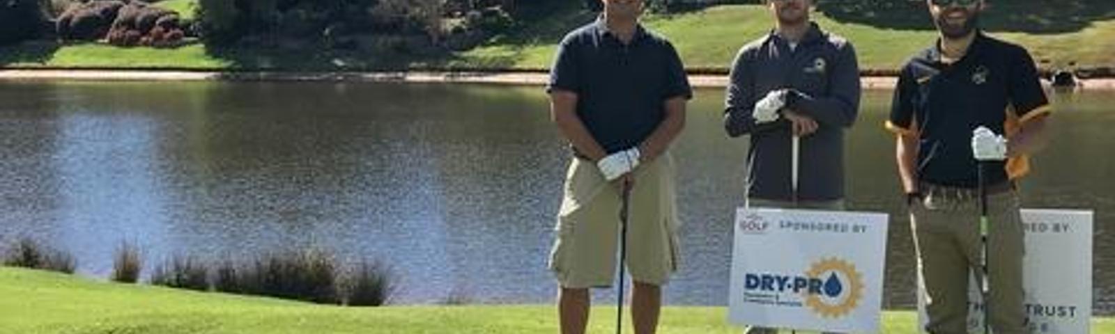 Three Dry Pro workers golf.