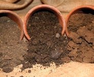Sand, loam and clay soils spilling out of pots
